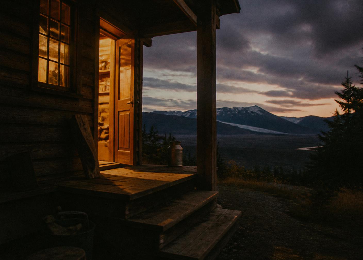Wooden porch steps at dusk with distant mountains