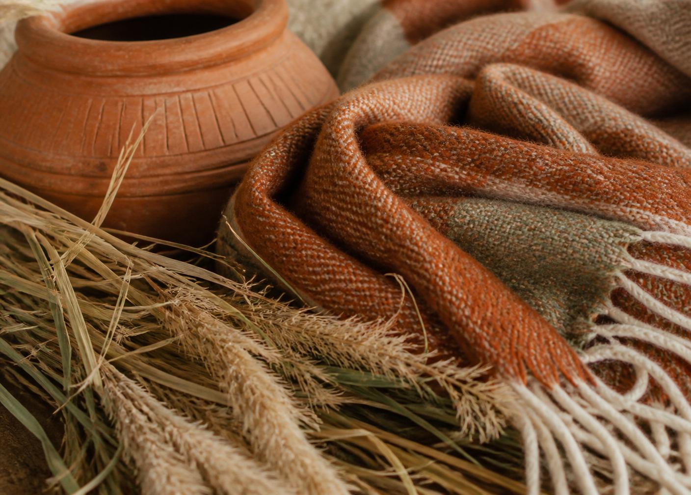 Warm woven textures and terracotta pottery